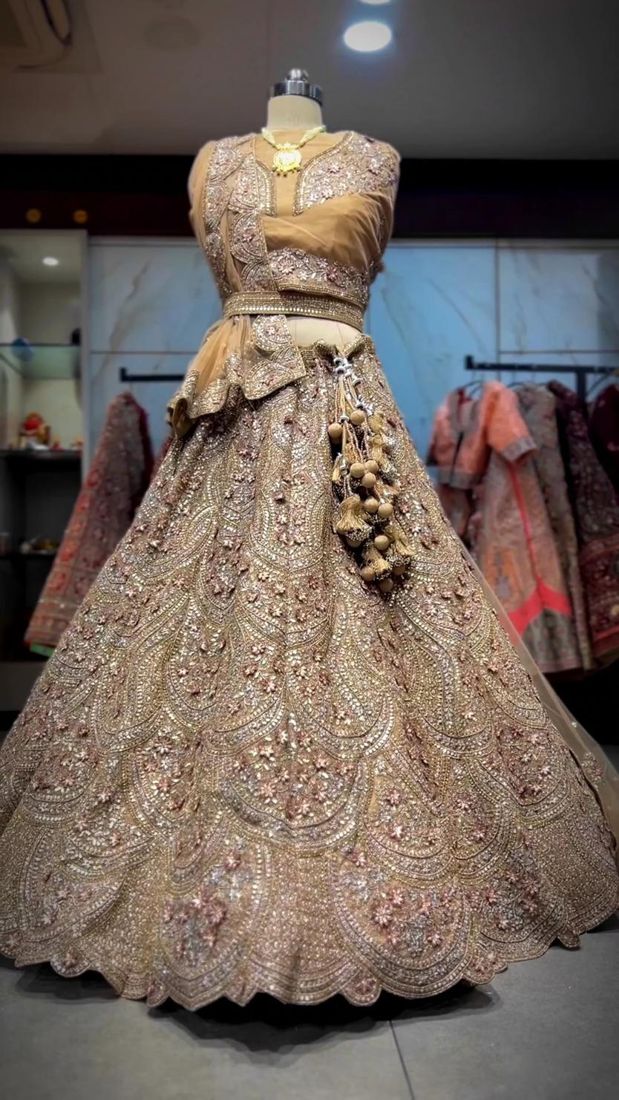 Champagne gold zari bridal lehenga on a mannequin in the studio